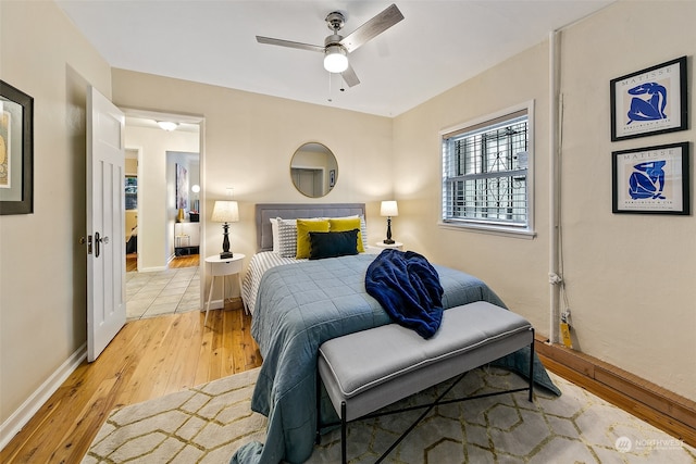 bedroom with light hardwood / wood-style flooring and ceiling fan