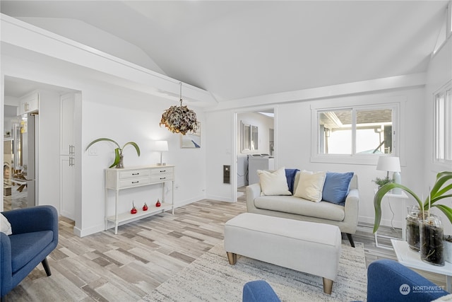 living room featuring light hardwood / wood-style floors and vaulted ceiling