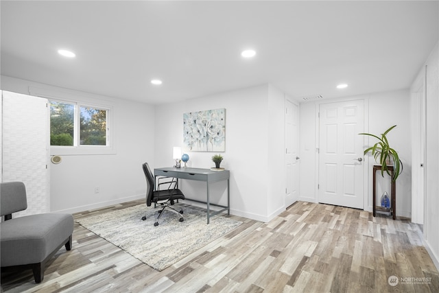 office with light hardwood / wood-style floors