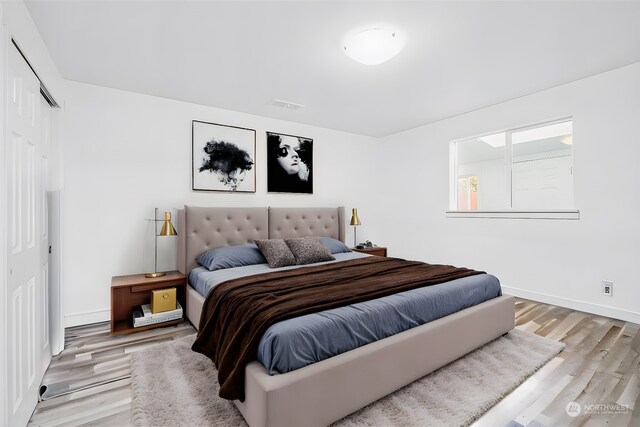 bedroom featuring light hardwood / wood-style flooring and a closet