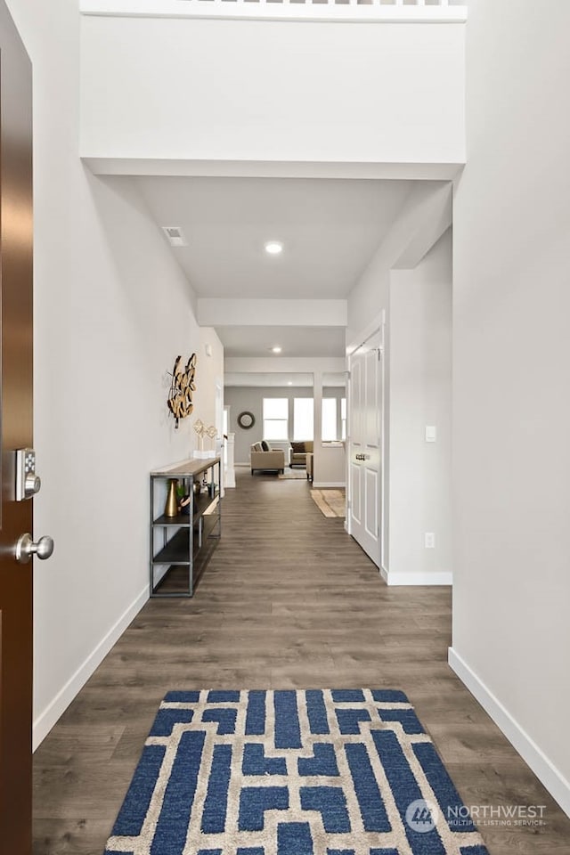 hallway featuring dark hardwood / wood-style flooring