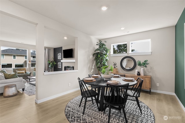 dining space with light hardwood / wood-style floors