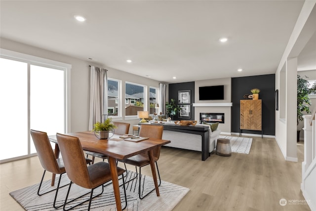 dining space with light hardwood / wood-style flooring and a wealth of natural light