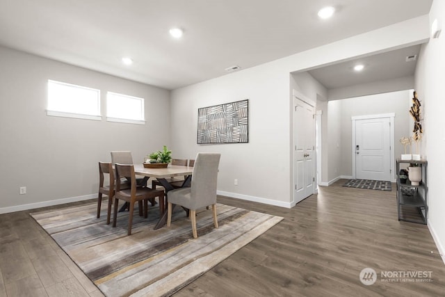 dining space with dark hardwood / wood-style floors