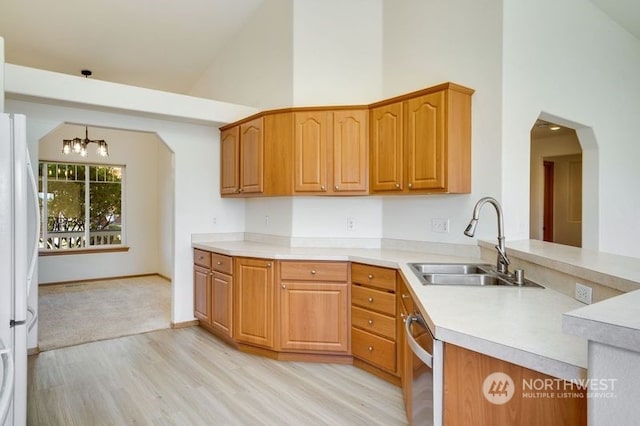 kitchen with dishwasher, sink, a chandelier, white fridge, and high vaulted ceiling