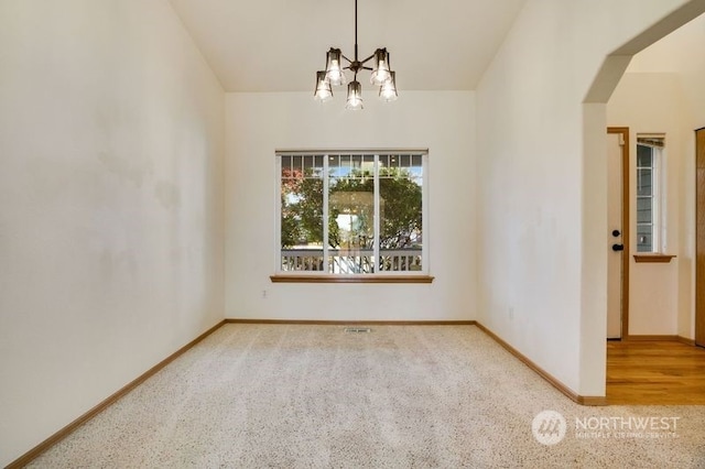 13703 68th Avenue Ct E, Puyallup, WA 98373 - empty room with a chandelier, baseboards, carpet, and arched walkways