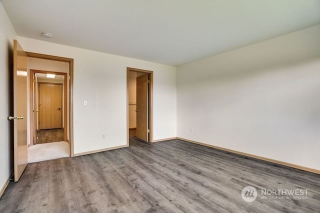 13703 68th Avenue Ct E, Puyallup, WA 98373 - unfurnished bedroom featuring wood finished floors, baseboards, and a spacious closet