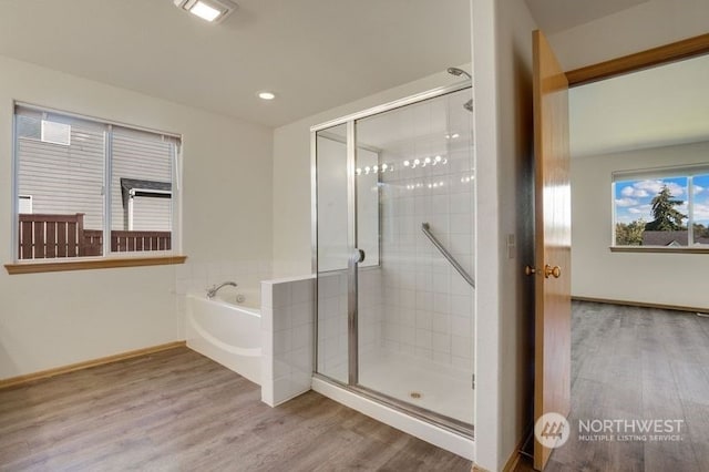 13703 68th Avenue Ct E, Puyallup, WA 98373 - bathroom with wood finished floors, a shower stall, a bath, recessed lighting, and baseboards