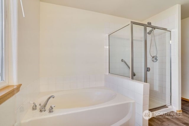 13703 68th Avenue Ct E, Puyallup, WA 98373 - bathroom with a shower stall, a bath, and wood finished floors