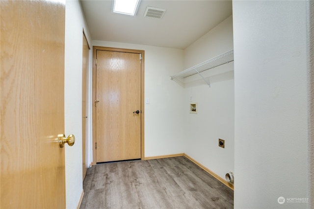 clothes washing area with hookup for an electric dryer, light hardwood / wood-style flooring, and washer hookup