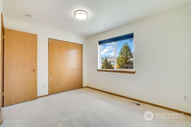 13703 68th Avenue Ct E, Puyallup, WA 98373 - unfurnished bedroom featuring a closet, carpet, and baseboards