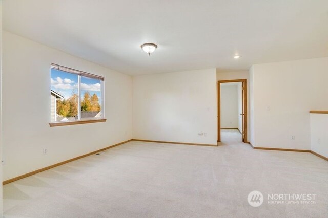 empty room featuring light colored carpet