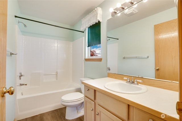 full bathroom with toilet, hardwood / wood-style flooring, vanity, and shower / bathtub combination