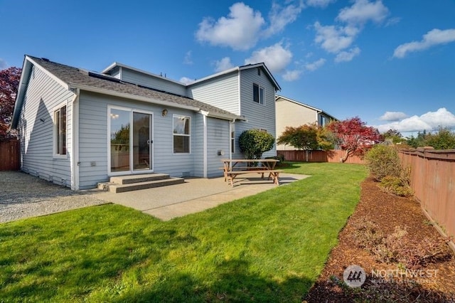 rear view of house featuring a patio area and a lawn