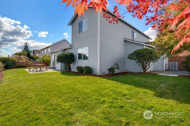 view of side of property with central AC, a patio area, and a lawn