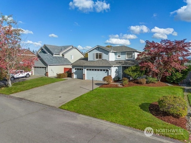 view of front of home featuring a front yard and a garage