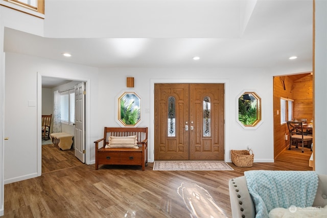 entryway featuring wooden walls and wood-type flooring