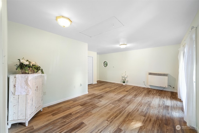 empty room featuring hardwood / wood-style flooring and radiator