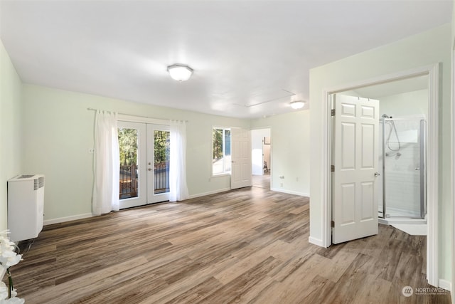 empty room with french doors and wood-type flooring