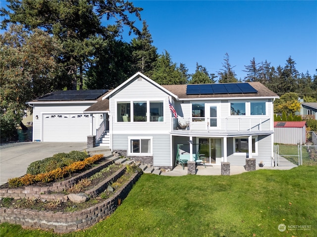 rear view of house with a patio area, solar panels, and a lawn