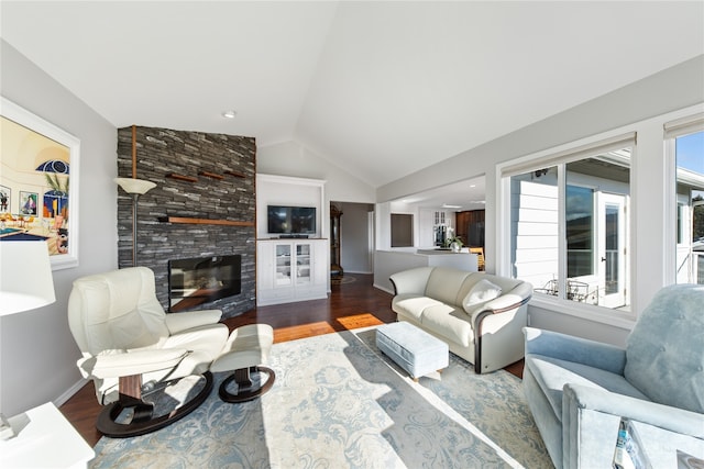 living room with hardwood / wood-style floors, a fireplace, and vaulted ceiling