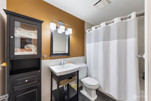 bathroom featuring vanity, toilet, and a shower with shower curtain