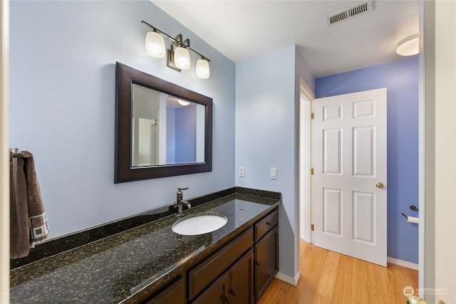 bathroom featuring vanity and hardwood / wood-style floors