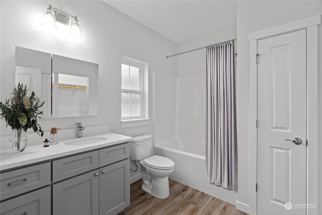 full bathroom with vanity, toilet, shower / bathing tub combination, and hardwood / wood-style floors