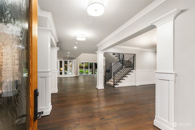 interior space with decorative columns, crown molding, and dark hardwood / wood-style floors