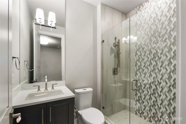 bathroom featuring vanity, toilet, and an enclosed shower