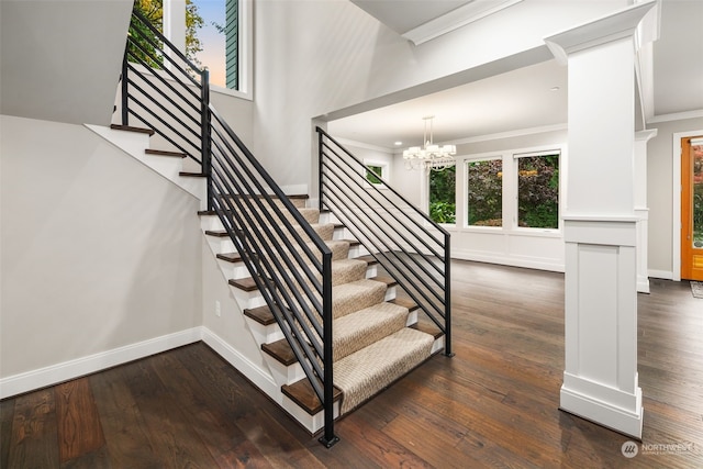 staircase with a notable chandelier, ornamental molding, and wood-type flooring