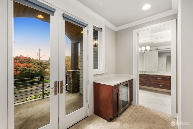 doorway with french doors, ornamental molding, and beverage cooler