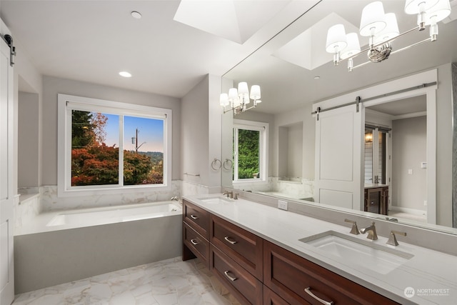 bathroom featuring vanity, a notable chandelier, and a bath