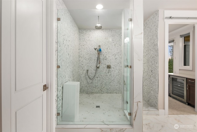 bathroom featuring a shower with door and wine cooler