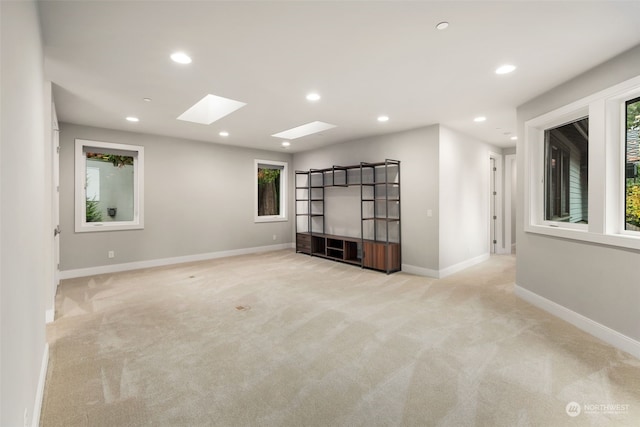 carpeted spare room with a skylight