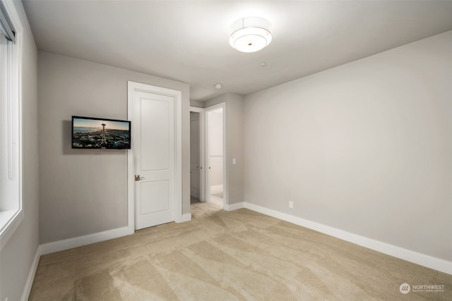 unfurnished bedroom featuring light colored carpet