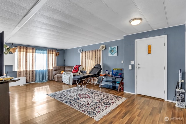 living room with hardwood / wood-style floors and a textured ceiling