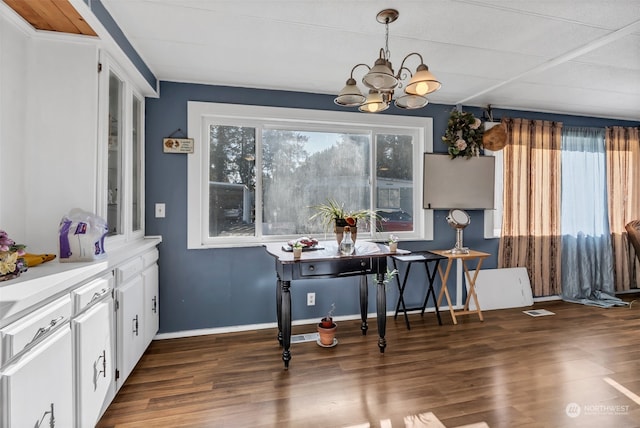 dining space with a chandelier and dark hardwood / wood-style flooring