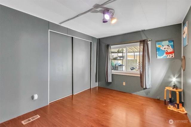 unfurnished bedroom featuring a closet and wood-type flooring