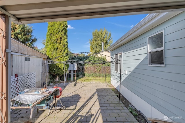 view of patio / terrace with a storage shed