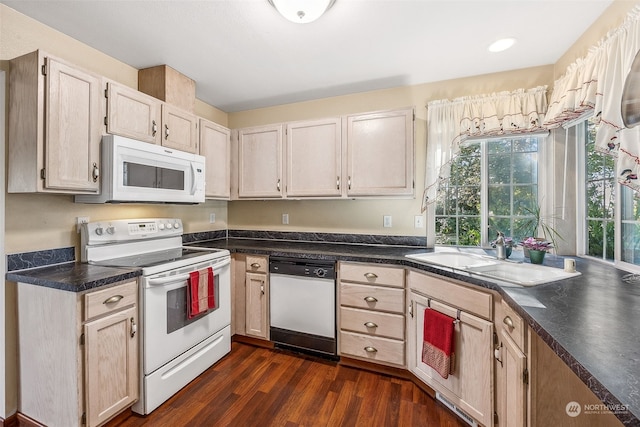 kitchen featuring white appliances, sink, and dark hardwood / wood-style floors