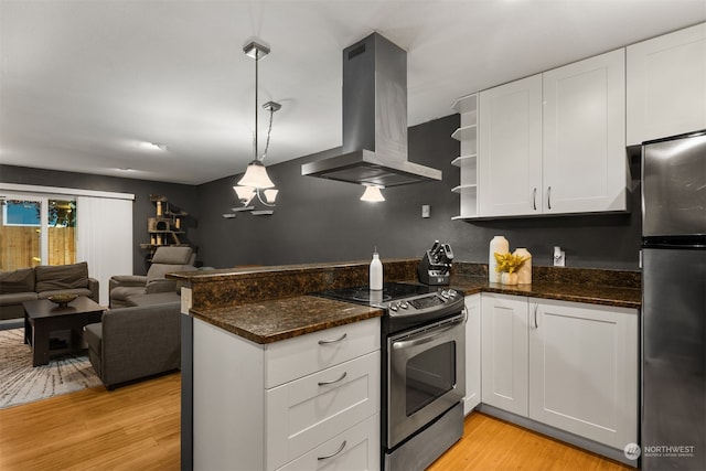 kitchen with range hood, appliances with stainless steel finishes, decorative light fixtures, and white cabinets