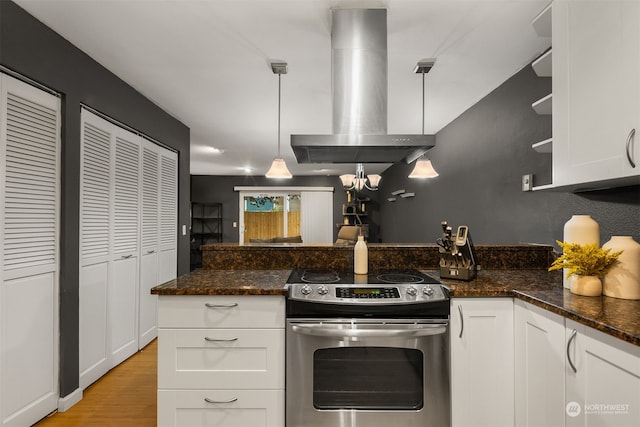 kitchen featuring stainless steel range with electric stovetop, white cabinetry, and pendant lighting