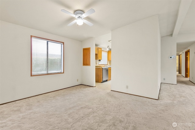 interior space featuring ceiling fan and light colored carpet