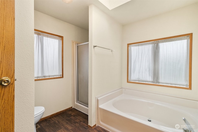 bathroom with hardwood / wood-style flooring, toilet, and shower with separate bathtub