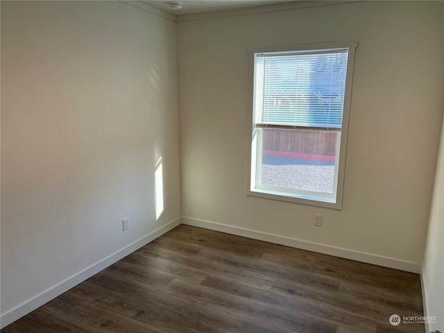 unfurnished room with dark wood-type flooring