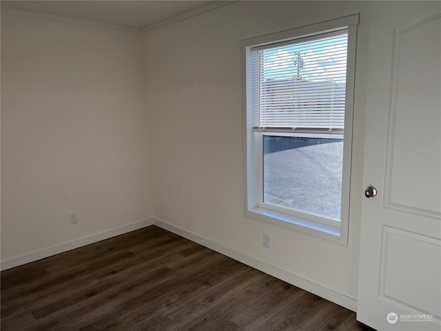 unfurnished room featuring ornamental molding and dark hardwood / wood-style flooring