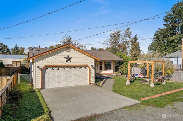 view of front of home with a front yard and a garage