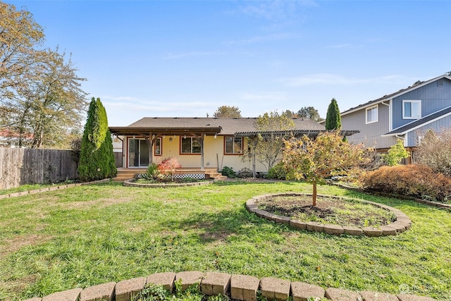 back of house featuring a yard