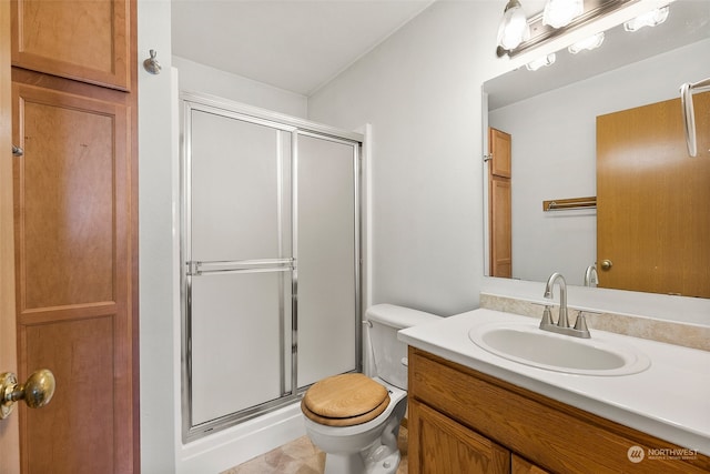 bathroom featuring toilet, walk in shower, and vanity